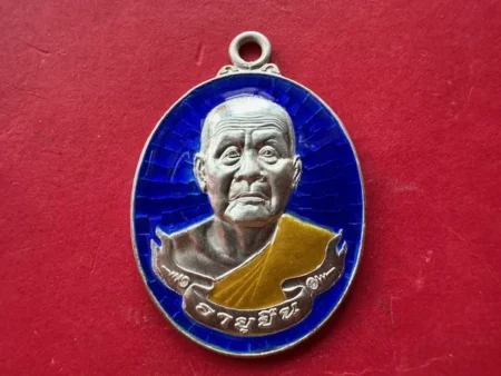 Wealth amulet B.E.2554 LP Boonnah silver coin with blue background – Long live batch (MON1123)